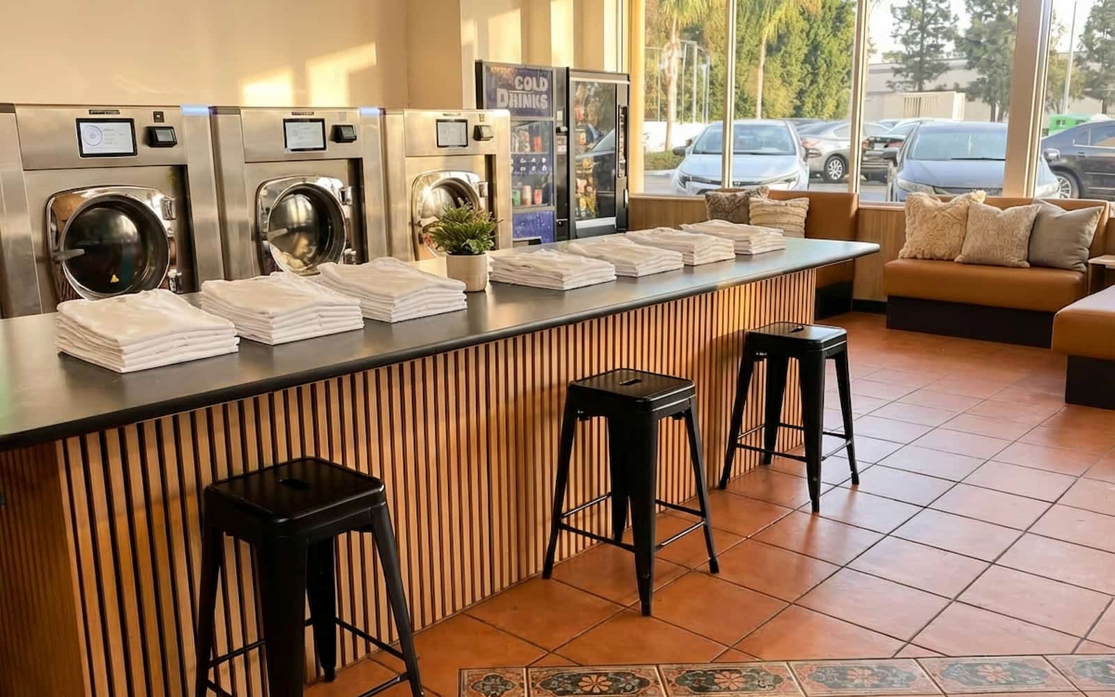 Clean folded clothes on a folding table at Polanco Laundry in Arleta